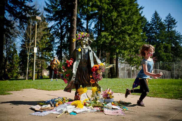 Fans leave tributes at the bronze statue of one of Beverly Cleary’s cherished characters, Ramona Quimby, at the Beverly Cleary Sculpture Garden in Portland, Ore. The author died March 25 at the age of 104.